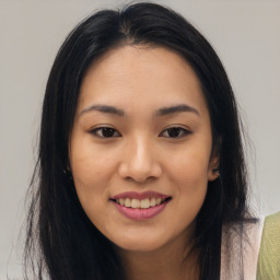 Joyful asian young-adult female with long  brown hair and brown eyes