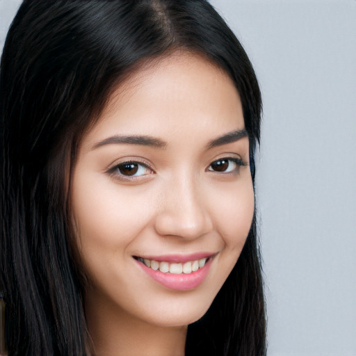 Joyful white young-adult female with long  black hair and brown eyes