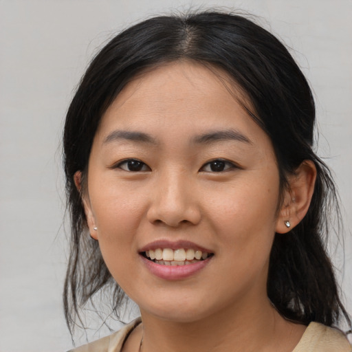 Joyful asian young-adult female with medium  black hair and brown eyes
