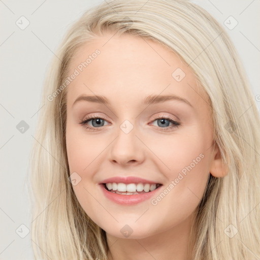 Joyful white young-adult female with long  brown hair and blue eyes