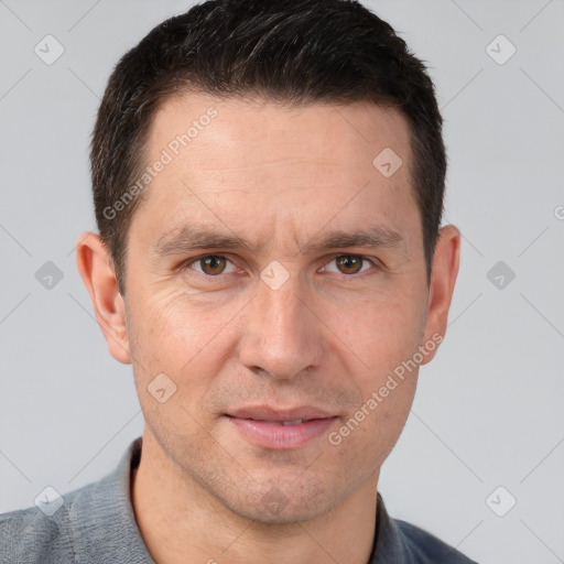 Joyful white adult male with short  brown hair and brown eyes