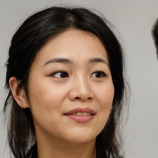 Joyful asian young-adult female with long  brown hair and brown eyes