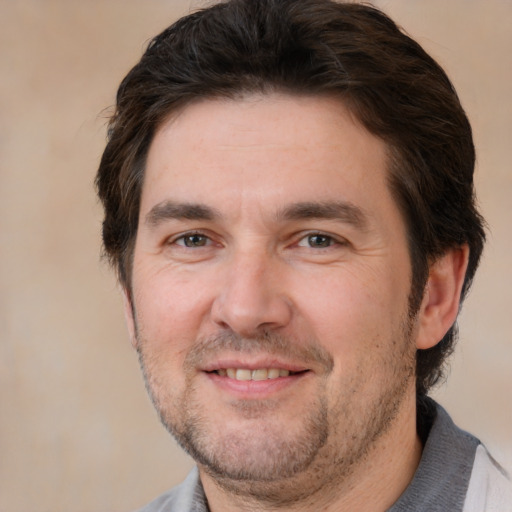 Joyful white adult male with short  brown hair and brown eyes