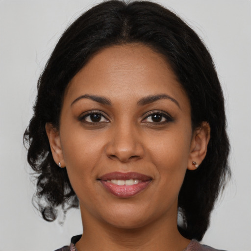 Joyful black young-adult female with medium  brown hair and brown eyes