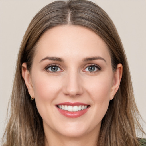 Joyful white young-adult female with long  brown hair and grey eyes