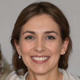 Joyful white adult female with medium  brown hair and brown eyes