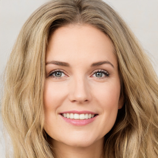 Joyful white young-adult female with long  brown hair and green eyes