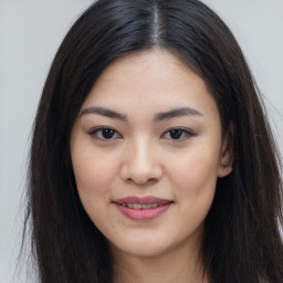 Joyful asian young-adult female with long  brown hair and brown eyes