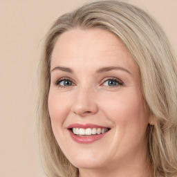 Joyful white young-adult female with long  brown hair and green eyes