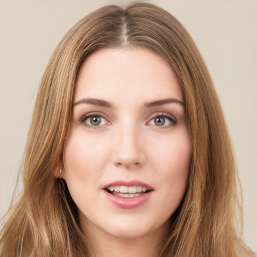 Joyful white young-adult female with long  brown hair and green eyes