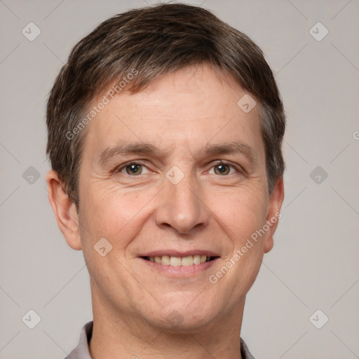 Joyful white adult male with short  brown hair and grey eyes