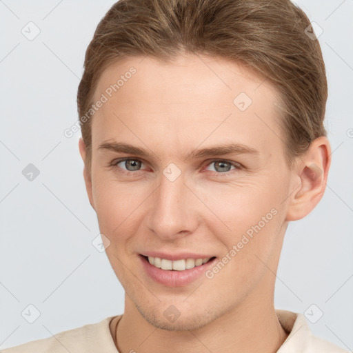 Joyful white young-adult female with short  brown hair and grey eyes