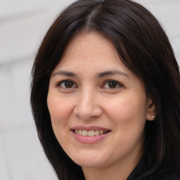 Joyful white adult female with long  brown hair and brown eyes