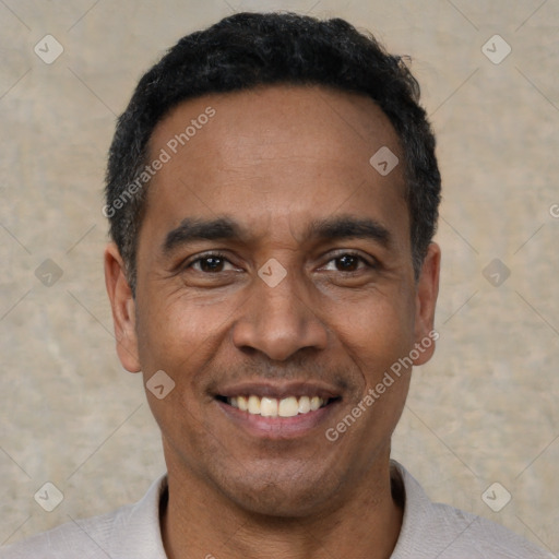 Joyful latino adult male with short  black hair and brown eyes