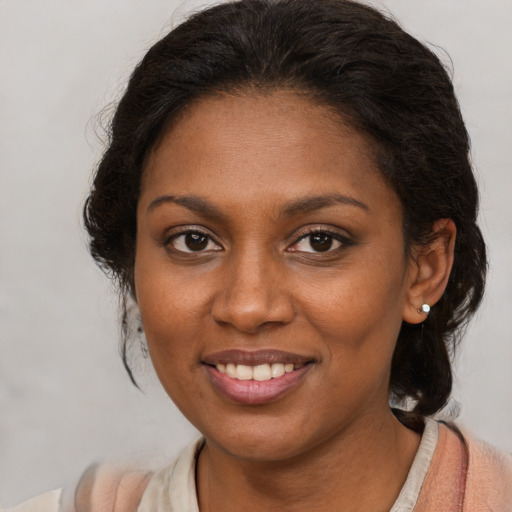 Joyful black young-adult female with medium  brown hair and brown eyes