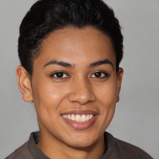 Joyful latino young-adult female with short  brown hair and brown eyes