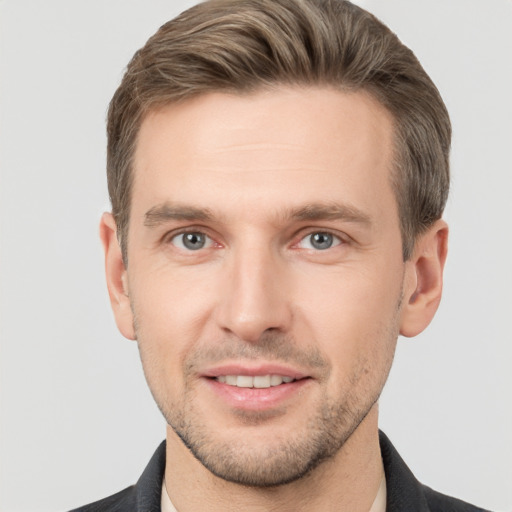 Joyful white young-adult male with short  brown hair and grey eyes