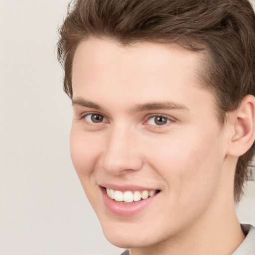 Joyful white young-adult male with medium  brown hair and brown eyes