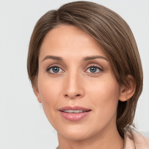 Joyful white young-adult female with medium  brown hair and grey eyes