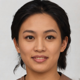 Joyful asian young-adult female with medium  black hair and brown eyes