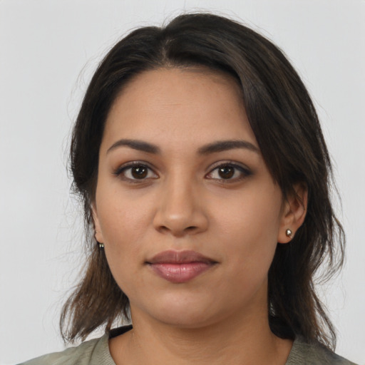 Joyful latino young-adult female with medium  brown hair and brown eyes