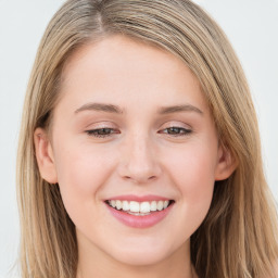 Joyful white young-adult female with long  brown hair and blue eyes