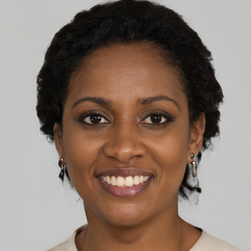 Joyful black young-adult female with medium  black hair and brown eyes