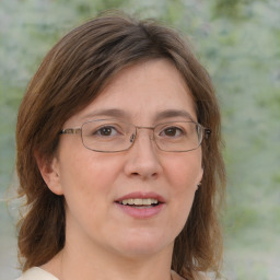 Joyful white adult female with medium  brown hair and blue eyes