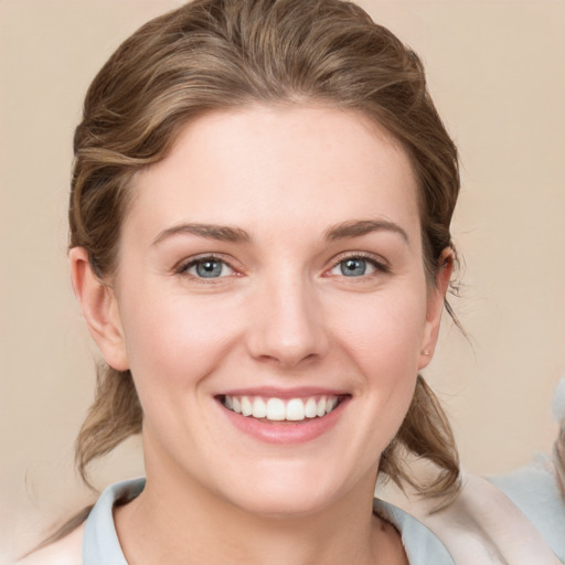 Joyful white young-adult female with medium  brown hair and grey eyes