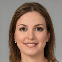 Joyful white young-adult female with long  brown hair and grey eyes