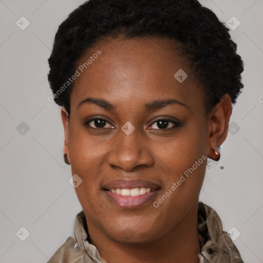 Joyful black young-adult female with short  brown hair and brown eyes