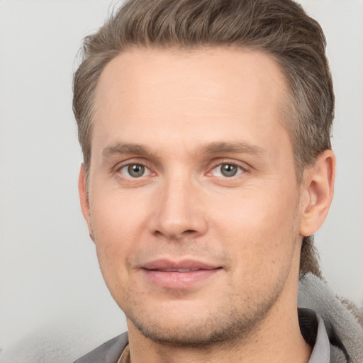 Joyful white adult male with short  brown hair and brown eyes