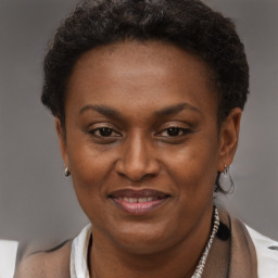 Joyful black adult female with short  brown hair and brown eyes