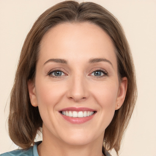 Joyful white young-adult female with medium  brown hair and grey eyes