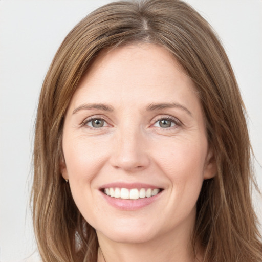 Joyful white young-adult female with long  brown hair and grey eyes