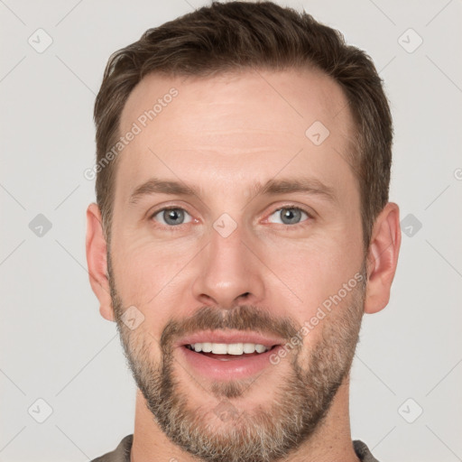 Joyful white young-adult male with short  brown hair and grey eyes