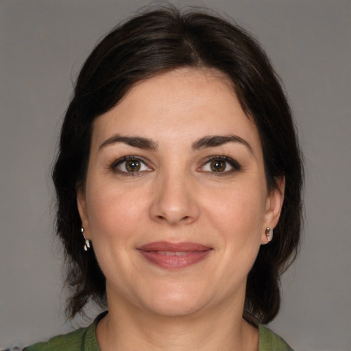 Joyful white adult female with medium  brown hair and brown eyes