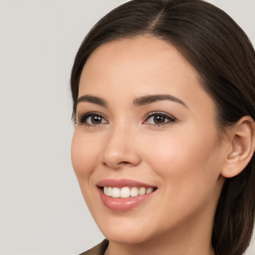 Joyful white young-adult female with long  brown hair and brown eyes