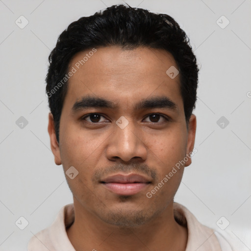 Joyful latino young-adult male with short  black hair and brown eyes