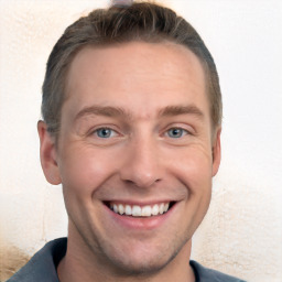 Joyful white young-adult male with short  brown hair and grey eyes