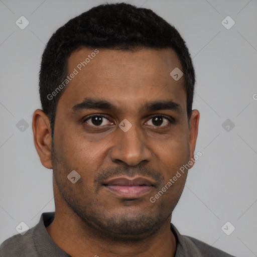 Joyful black young-adult male with short  black hair and brown eyes