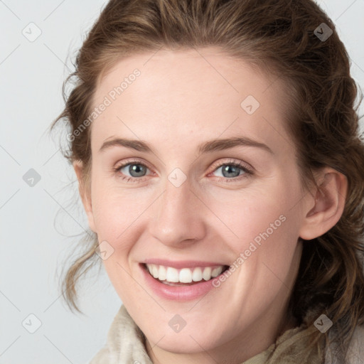 Joyful white young-adult female with medium  brown hair and blue eyes