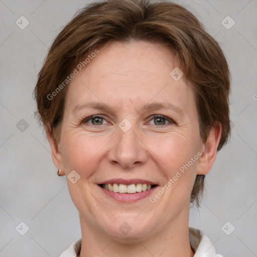 Joyful white adult female with medium  brown hair and grey eyes