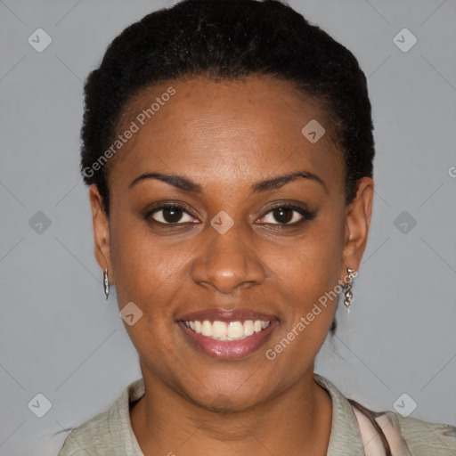 Joyful black young-adult female with short  black hair and brown eyes