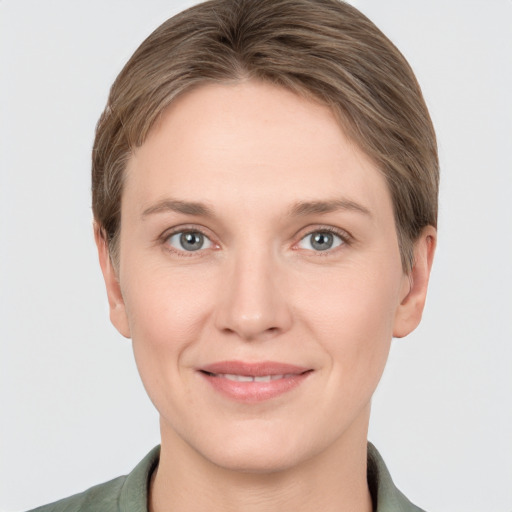 Joyful white young-adult female with short  brown hair and grey eyes