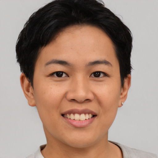 Joyful asian young-adult female with short  black hair and brown eyes