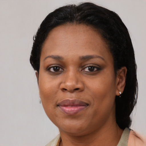 Joyful black adult female with short  black hair and brown eyes