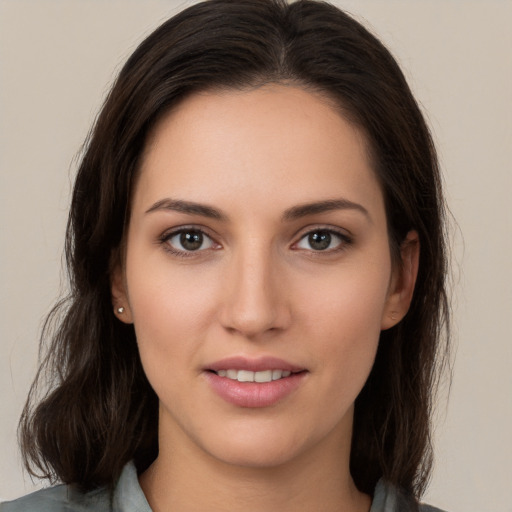 Joyful white young-adult female with long  brown hair and brown eyes