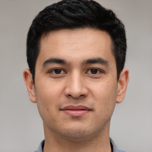 Joyful white young-adult male with short  black hair and brown eyes