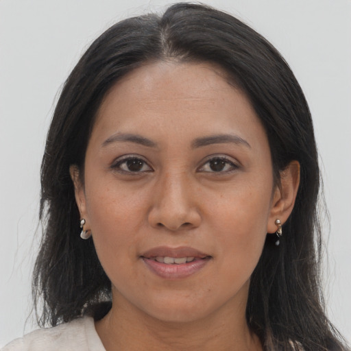 Joyful asian young-adult female with long  brown hair and brown eyes